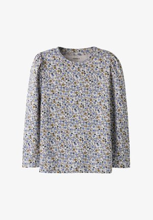 Kinderbloes met lange mouwen en een dicht patroon van kleine blauwe, gele en zwarte bloemen op een lichte achtergrond.