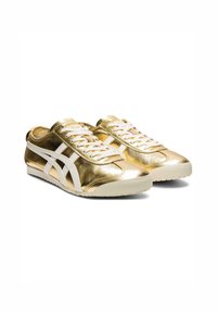 Gold metallic sneakers with white accents, lace-up design, smooth texture, round toe, and a soft white sole.