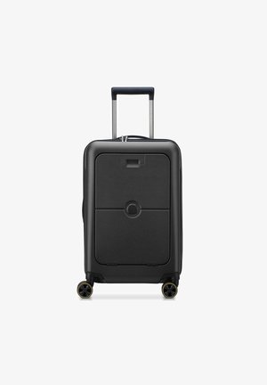 Valigia rigida nera con superficie piatta, manico superiore estraibile e quattro ruote nere con dettagli gialli. La parte anteriore presenta un dettaglio con logo circolare.