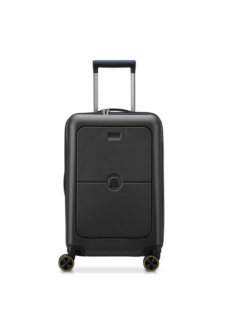 Valigia rigida nera con superficie piatta, manico superiore estraibile e quattro ruote nere con dettagli gialli. La parte anteriore presenta un dettaglio con logo circolare.