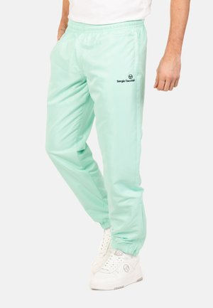 Jogging léger vert menthe avec taille élastique, jambes fuselées et détail de logo sur la cuisse gauche. Fabriqué à partir d'un matériau lisse et léger.