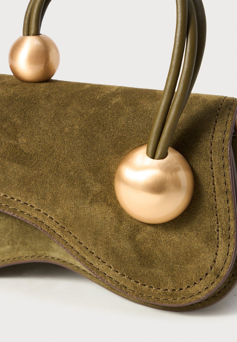 Olive suede handbag with rounded metallic accents, featuring two green handles and contrasting stitching along the edges.