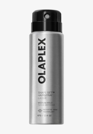 Lata cilíndrica plateada de laca para el cabello Olaplex Shape Set con tapa negra, etiquetada con fijación media y tecnología patentada de enlaces.