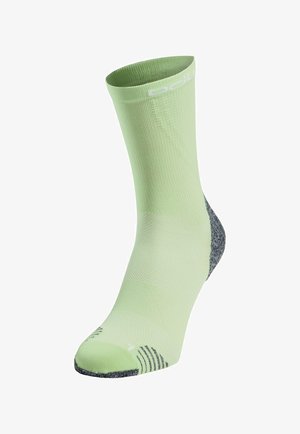 Light green athletic sock featuring a ribbed texture, gray heel and toe accents, and reflective branding at the cuff.