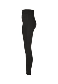 Leggings noirs avec une taille haute, texture lisse et design près du corps. Le tissu semble extensible, adapté à un usage actif.