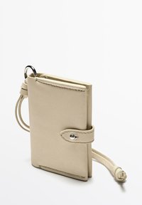 Light beige leather wallet with a keyring attachment, featuring a fold-over design, snap-button closure, and a textured surface.