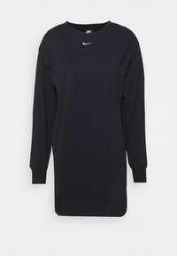 Svart långärmad skjorta i bomull. Har en rund halsringning och en vit Nike-logotyp på bröstet. Manschetterna är åtsittande.