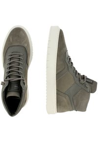 High-top sneakers made of grey suede and fabric, featuring a white rubber sole, grey laces, and a textured finish with side logo detail.