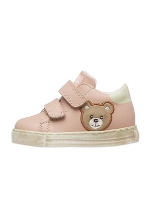 Zapatilla deportiva rosa para niños con dos tiras de velcro y una cara de oso bordada en el lateral, con una suela blanca ligeramente desgastada.