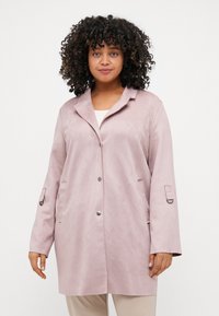 Light pink, suede-like jacket with a lapel collar, front button closure, and side pockets. Features long sleeves with strap details.