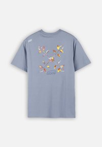 T-shirt à manches courtes bleu clair en coton, présentant un motif floral et géométrique coloré au dos et un petit logo sur l'épaule.