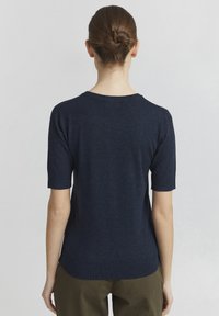 Navy blue short-sleeve sweater in a smooth knit fabric. Features a crew neckline and subtle ribbed accents at the hem and sleeves.