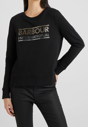Black sweatshirt made of cotton, featuring a round neckline, long sleeves, and a metallic logo design in gold and silver.