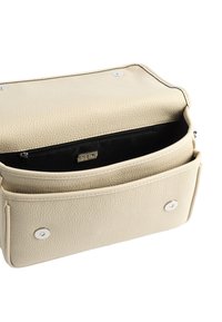 Beżowa skórzana torba na ramię o fakturowanej powierzchni, z kieszenią na zamek błyskawiczny wewnątrz, dwoma zapięciami na napy oraz usztywnioną konstrukcją.