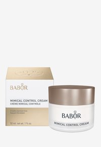 Babor Mimical Control Cream in a clear glass jar with a bronze lid, alongside a gold and white box, features elegant branding and text.