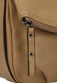 Tasche aus braunem Leder mit strukturiertem Oberflächen, akzentuiert durch braune Nähte, einem Reißverschluss und Hardware-Details in Silber.