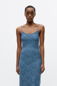 Blue spaghetti strap dress with a fitted silhouette, featuring a floral pattern in light blue, made of a smooth, slightly shiny fabric.