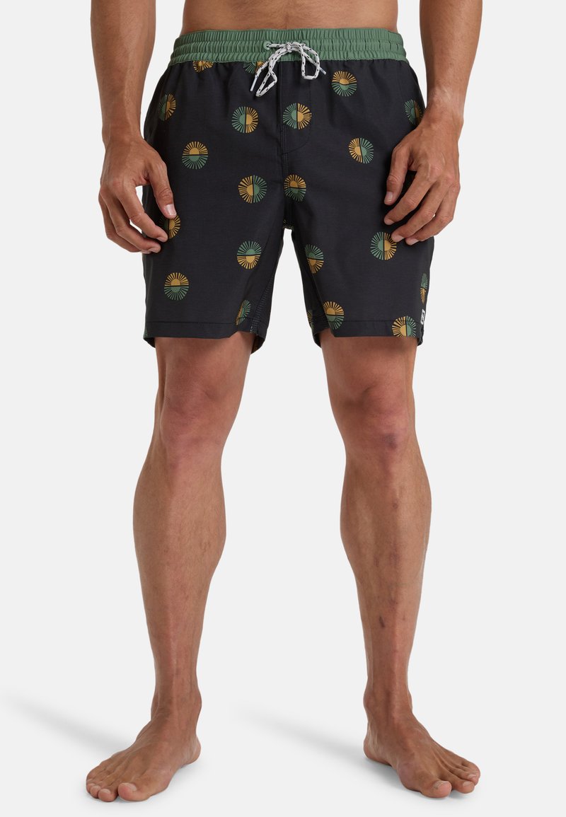 Pantaloni da nuoto realizzati in tessuto scuro, con un motivo geometrico ripetuto in verde e giallo, dotati di una vita elastica e cordino.