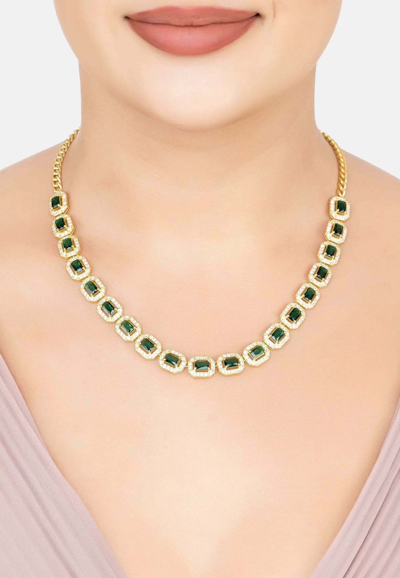 Gold-tone necklace featuring emerald-cut green gemstones set in rectangular frames, with a braided chain design.
