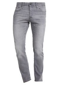 Slim-fit grå jeans i denim. Funktioner inkluderar framfickor, knapplåst och subtil blekning. Sömmar med stickade detaljer.