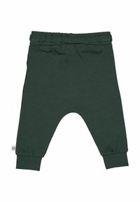 Grüne Baumwoll-Haremshose mit elastischem Bund, schmal zulaufenden Bündchen und lässiger Passform. Mit einem kleinen Logo-Label an der Seitennaht.