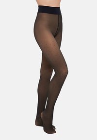 Collants noirs transparents avec un motif à pois, ceinture opaque, texture lisse et design avec pieds. Convient à diverses tenues.