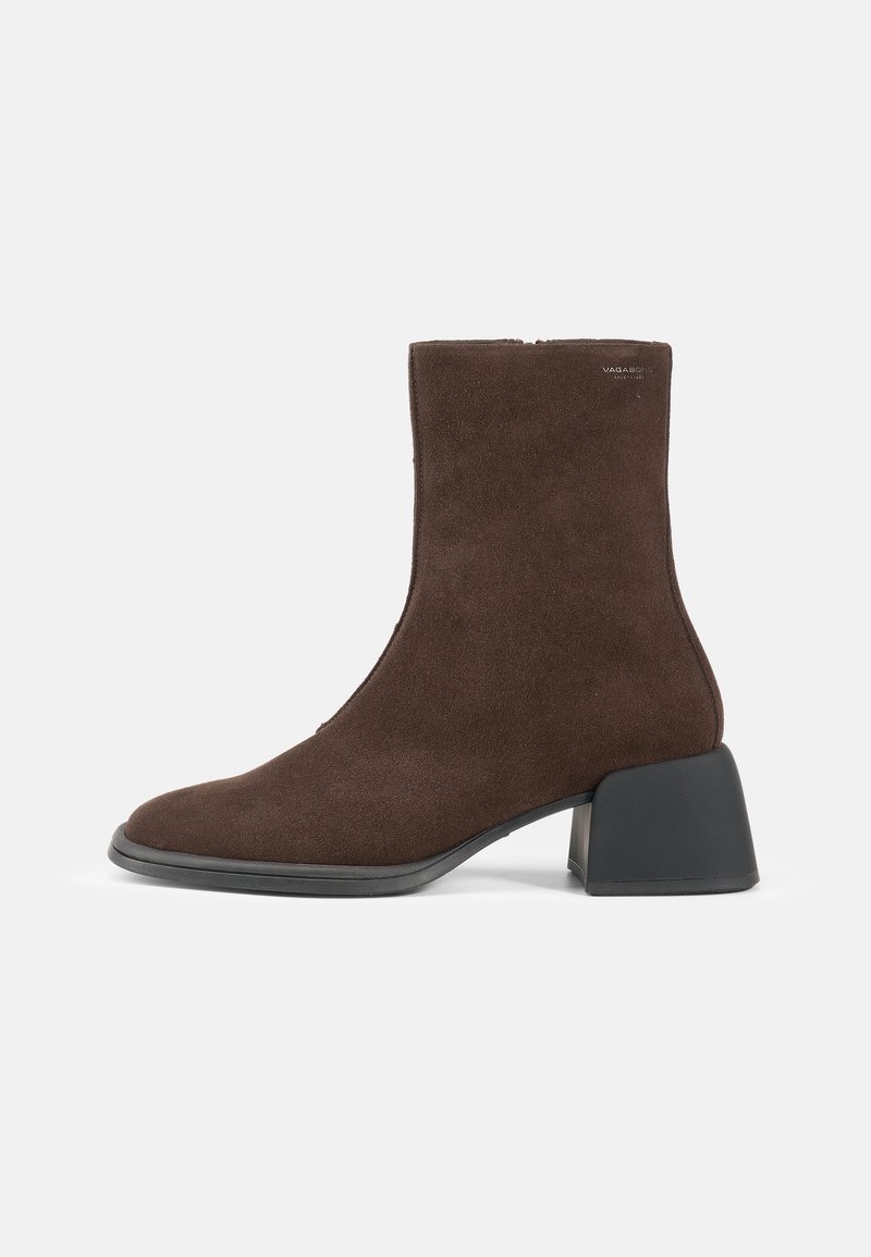 Brown suede ankle boot with a square toe, mid-block heel, and a smooth black sole. Features a side zipper for easy wear.