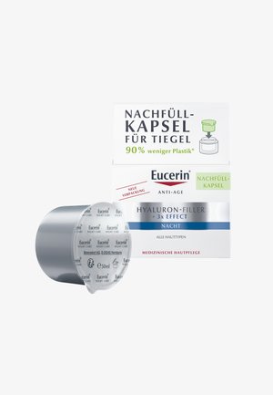 Eucerin night refill capsules in a circular silver container. Packaging labeled green for reduced plastic usage. Text in black and blue.