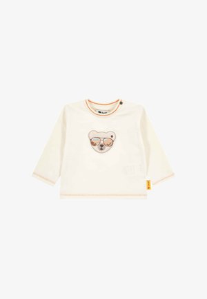 Chemise pour bébé à manches longues couleur crème avec des coutures orange et un visage d'ours portant des lunettes de soleil brodé sur la poitrine.