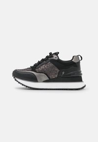 Czarne sportowe sneakersy z teksturowaną siateczkową cholewką, metalicznymi akcentami i grubą białą podeszwą środkową. Posiadają czarną gumową podeszwę zewnętrzną zapewniającą przyczepność.