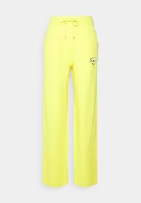 Gula sweatpants i mjukt tyg med elastisk midja och justerbar dragsko. Har en tryckt hjärtgrafik med text.