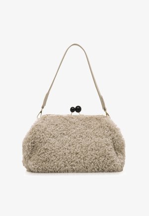 Beige synthetische bont handtas met een gestructureerd oppervlak, gouden sluiting en een dunne schouderband. Heeft twee ronde zwarte accenten bovenop.