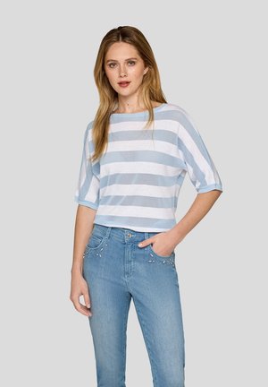 Cotton blend top with light blue and white horizontal stripes, short sleeves, and a relaxed fit. Paired with light blue jeans featuring embellishments.