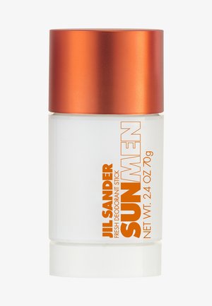 Bâtonnet de déodorant avec un corps blanc givré et un capuchon métallique orange. L'étiquette présente un texte orange en gras. Contient 70 g de produit.