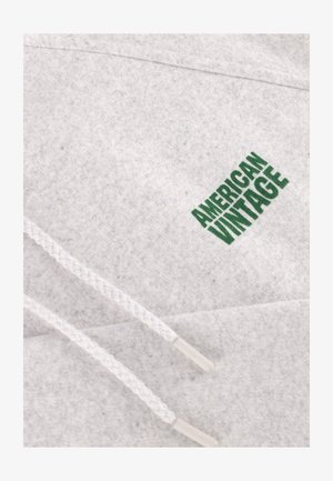 Light gray sweatshirt featuring a woven white drawstring and a green "AMERICAN VINTAGE" logo on the front. Soft texture with a casual design.