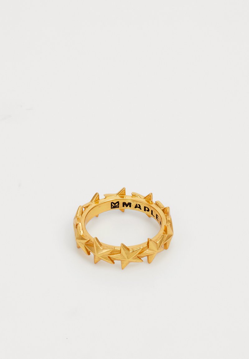 Kuldne metallrõngas, millel on tähekuju disain rõnga ümber, siledaga viimistlus ja brändinimi graveeritud sisepinnale.