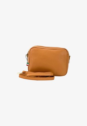 Tan leather crossbody bag with a textured surface, rectangular shape, gold zipper, and detachable strap. Features a small Italian flag accent.