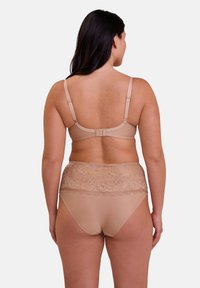 Soutien-gorge beige et culottes taille haute avec une bande en dentelle florale. Le tissu est lisse, avec des bretelles réglables et un fermoir à crochets.