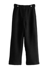 Pantalons noirs à jambes larges en tissu texturé, dotés de deux boutons à l'avant et d'une taille plate. La longueur arrive au mollet.
