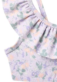 Haut en tissu violet clair avec un col à volants, orné d'un motif floral aux tons pastel rose, vert et lavande.