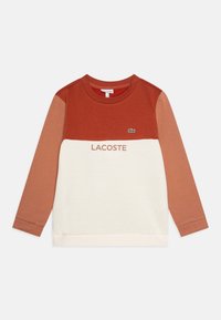 Felpa a blocchi di colore con sezioni in arancione ruggine, beige e crema. Presenta una finitura testurizzata, scollo rotondo e un piccolo logo ricamato.