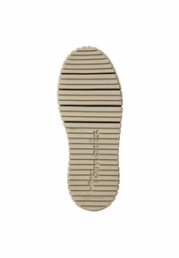 Beige rubber shoe sole with horizontal ridges, featuring a circular heel and text imprint "Tamaris 37 Made in Portugal."