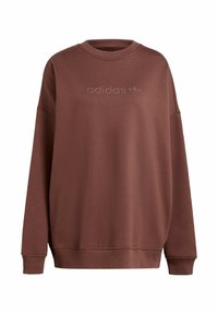 Hnědá mikina s kulatým výstřihem a dlouhými rukávy. Na hrudi se nachází tónové logo 'adidas'. Vyrobena z měkké tkaniny s hladkým povrchem.