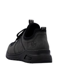 Black athletic shoe with a smooth suede finish, lace closure, padded collar, and textured heel accent with logo detail.
