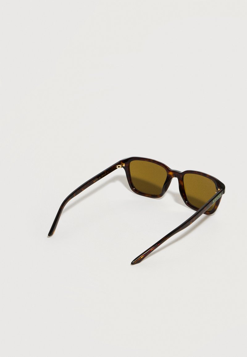 Tortoiseshell rectangular sunglasses with brown lenses and thin arms, shown at a slight angle on a plain white background.