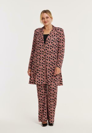 Gemusterter Anzug in Schwarz, Pink und Blau mit einem Blazer und passenden Hosen, die ein übergroßes Kreismuster aufweisen; glattes Material, taillierte Passform.