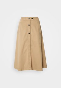 Jupe en khaki à boutons, fabriquée en coton. Présente une fente à l'avant, deux poches latérales et une taille élastique. Cinq boutons noirs à l'avant.