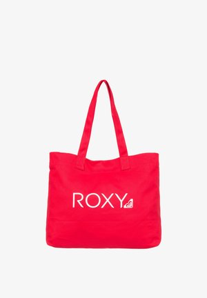 Red canvas tote bag with two sturdy straps, featuring the white "ROXY" logo and a small logo graphic in the bottom corner.