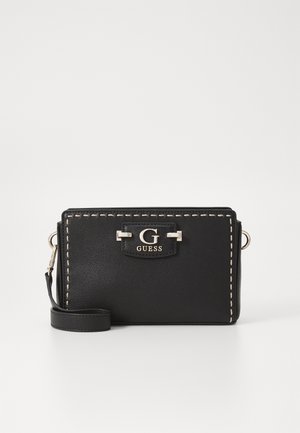 Zwart Guess polsbandje met witte stiksels, zilveren "G" logo-plaatje en een afneembare band op een witte achtergrond.