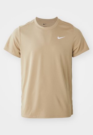 Beige Nike short-sleeve t-shirt made of lightweight fabric. Features a round neckline and a small white swoosh logo on the upper left chest.